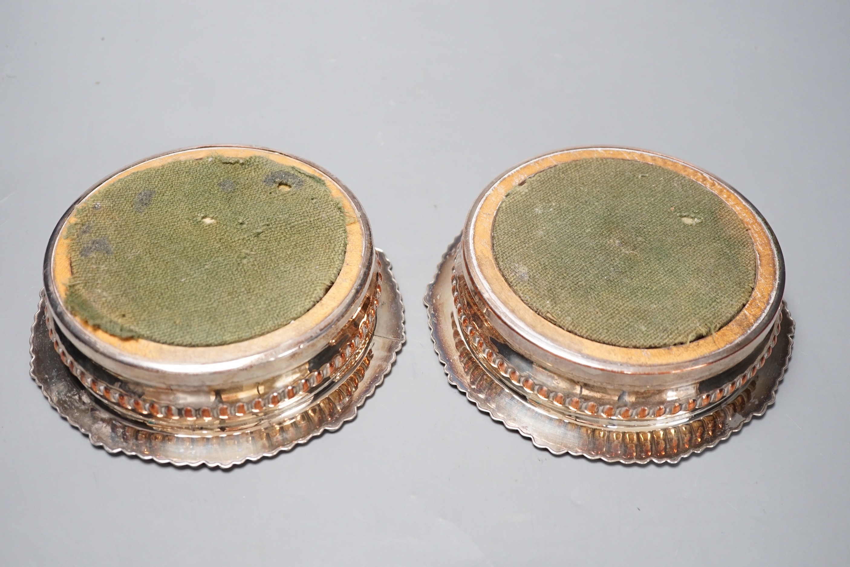 A pair of Regency Old Sheffield plate decanter coasters. 17cm diameter.